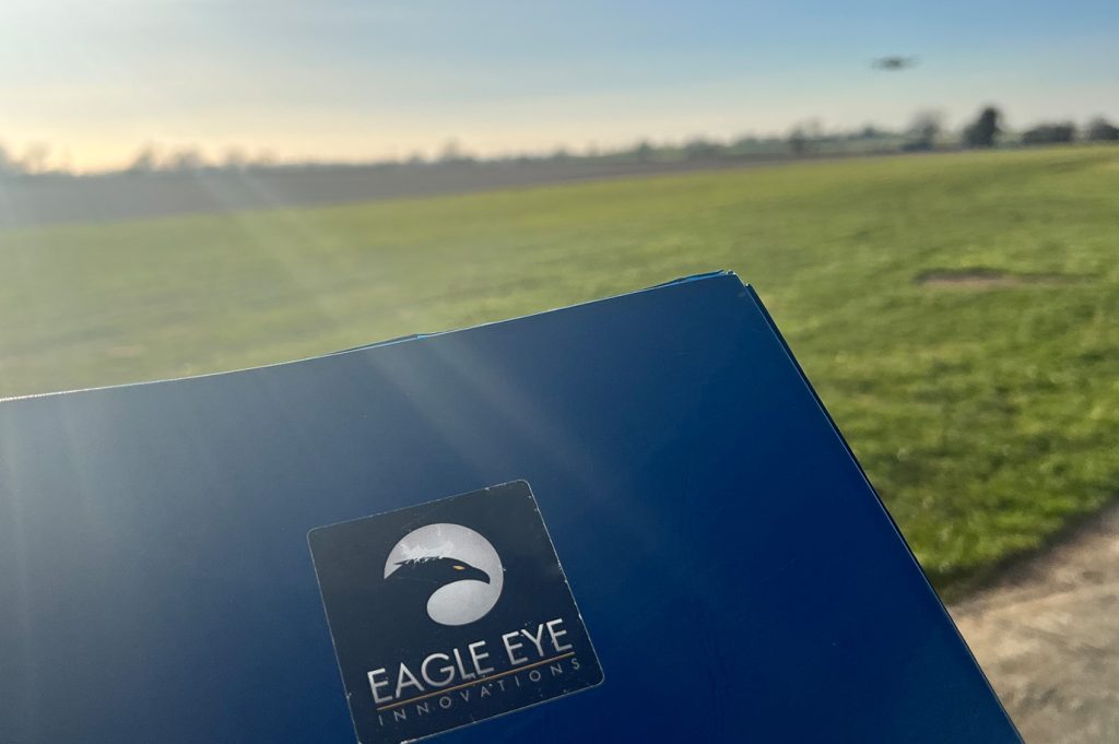 Close up of folder with drone flying in the background.