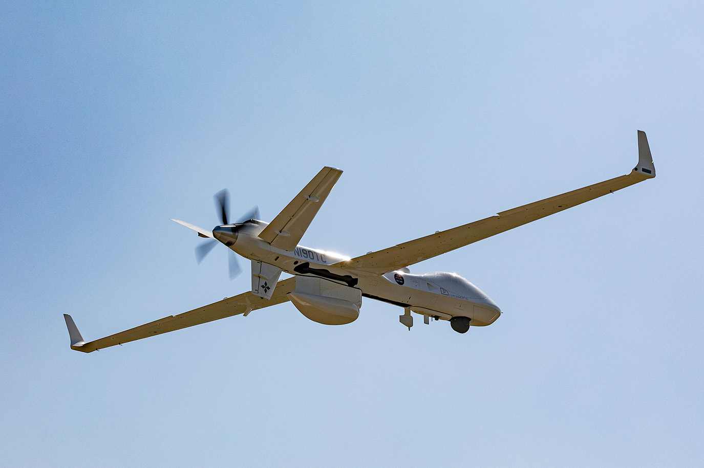 Image of Protector aircraft flying in open blue sky.