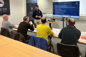 Man stood at front of classroom delivering drone theory training.